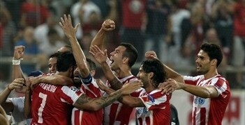 Olympiakos players celebrate a goal vs. Atletico [via @ChampionsLeague]