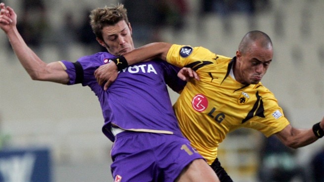 Viola own goal keeps AEK afloat