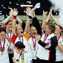 Tina Theune-Meyer lifts the trophy with her triumphant Germany team